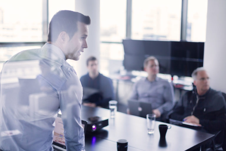 business-coach-running-presentation-in-office-boardroom (314449955)